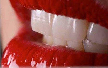 Close up of white teeth with red lips